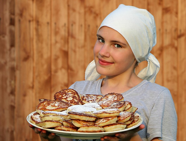 lovely young girl holding pancakes